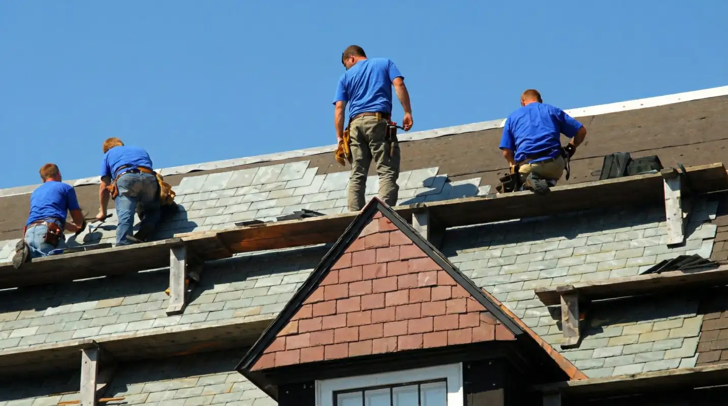 Roof replacement in progress with a team of professional contractors installing new shingles on a residential home in Cleveland, OH