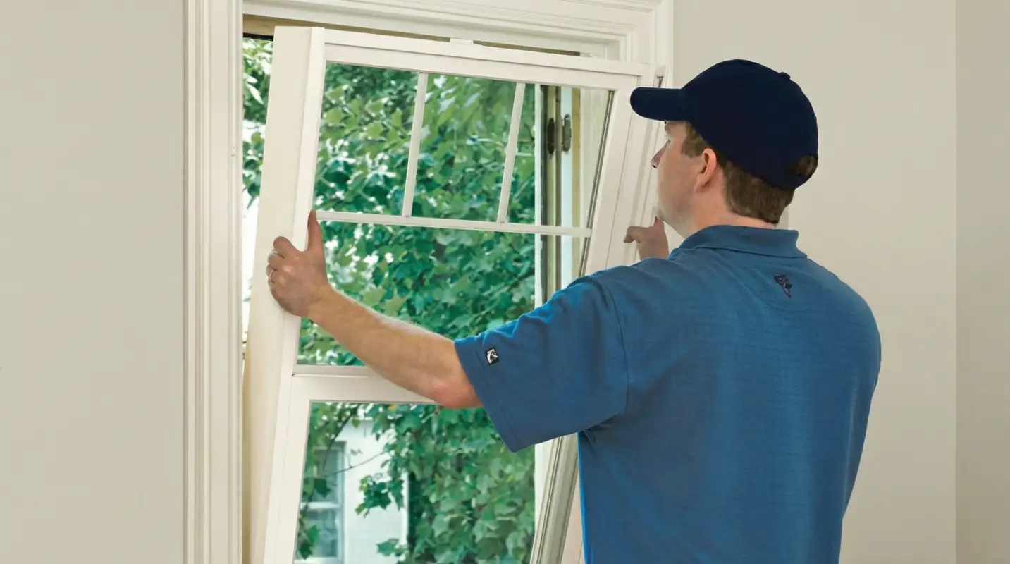 Professional contractors performing a residential window insulation and replacement service in Cleveland, OH
